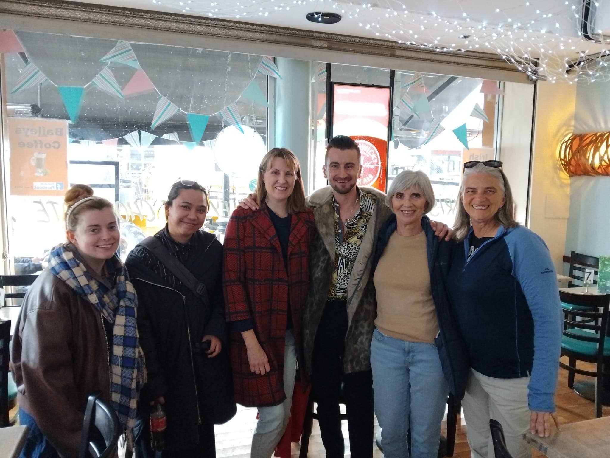 Retro Routes guide with happy tour guests in a Dublin café